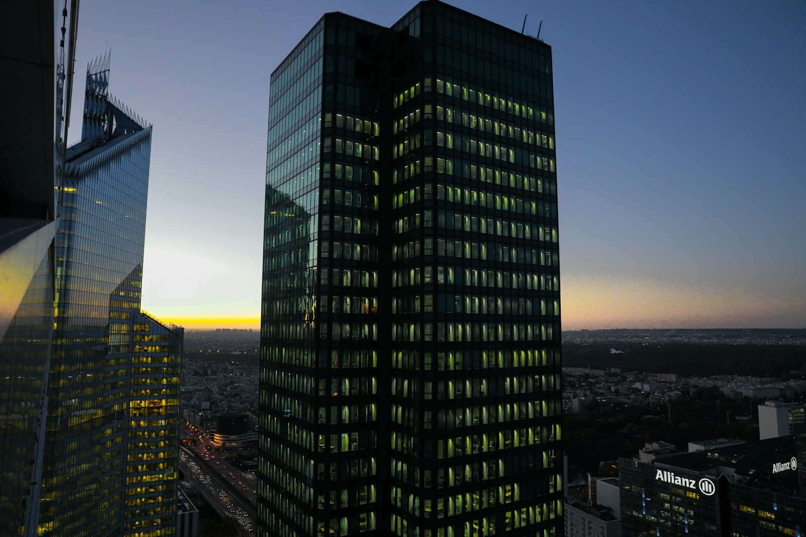 a couple of tall buildings with lights on at night